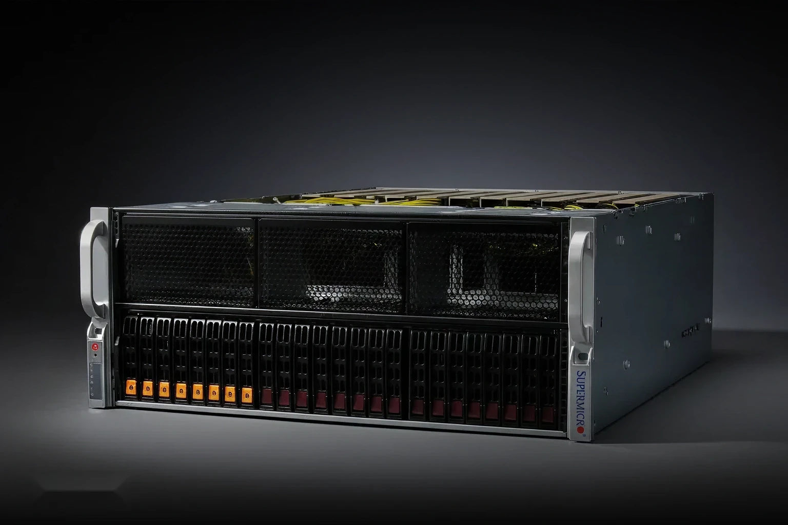 Side-angle view of the SuperMicro SYS-421GE-TNRT inside a data center cabinet with networking equipment and organized yellow cabling.
